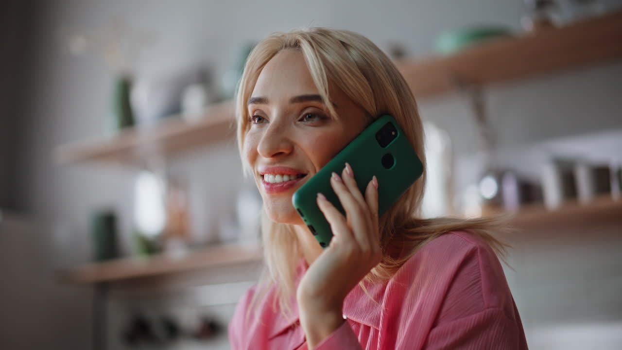 Laughing girl talking mobile phone at apartment portrait. Happy woman calling
