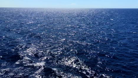 caribbean waters roll past, with its deep blue color