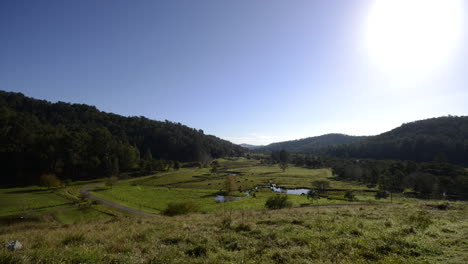 Time-lapse-of-foggy-clouds-clearing-away-to-reveal-a-cow-far-in-a-idyllic-valley