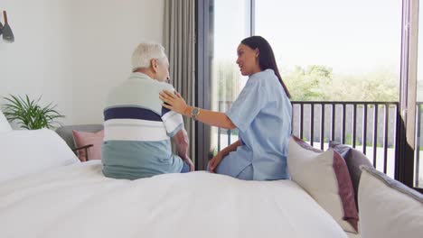 animation of biracial female doctor and caucasian senior man talking