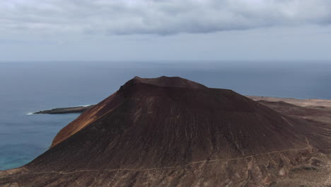 Fantastic-aerial-shot-over-the-Montaña-Amarilla-on-the-island-of-La-Graciosa-on-a-sunny-day