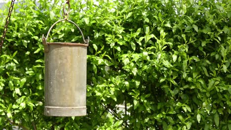 cinemagraph loop: metal bucket is swaying in wind