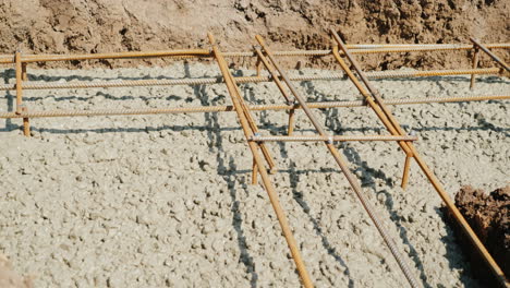 concrete fills the form of the foundation flows over the reinforcement country building