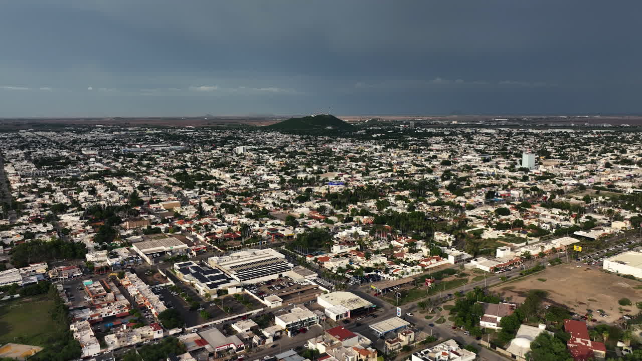 Drone flyover the cityscape of Los Mochis city, sunny day in Sinaloa, Mexico