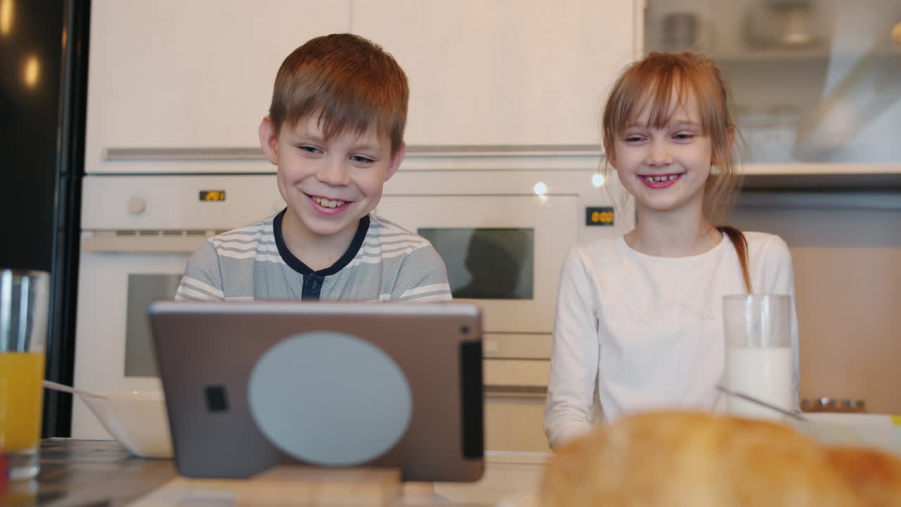 Children Watching Tablet at Breakfast