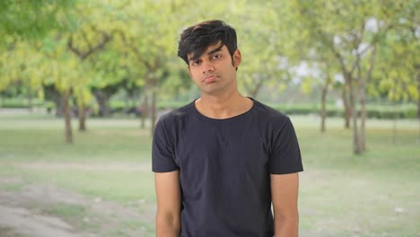 Upset-Indian-man-standing-in-a-park