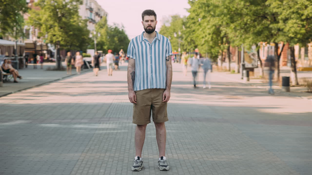 Man in Striped Shirt and Shorts on City Street