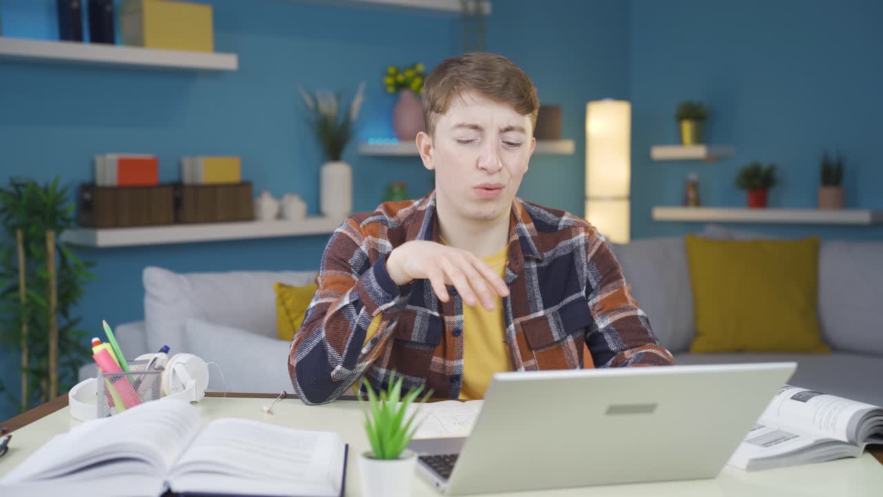 Student giving negative reaction on laptop. He doesn't like it and doesn't want it.