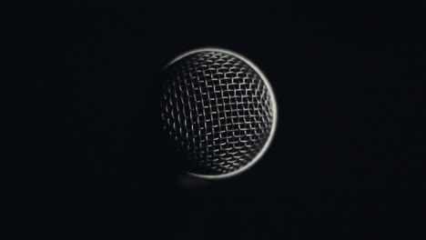 lighty slowly rotating around microphone in complete darkness