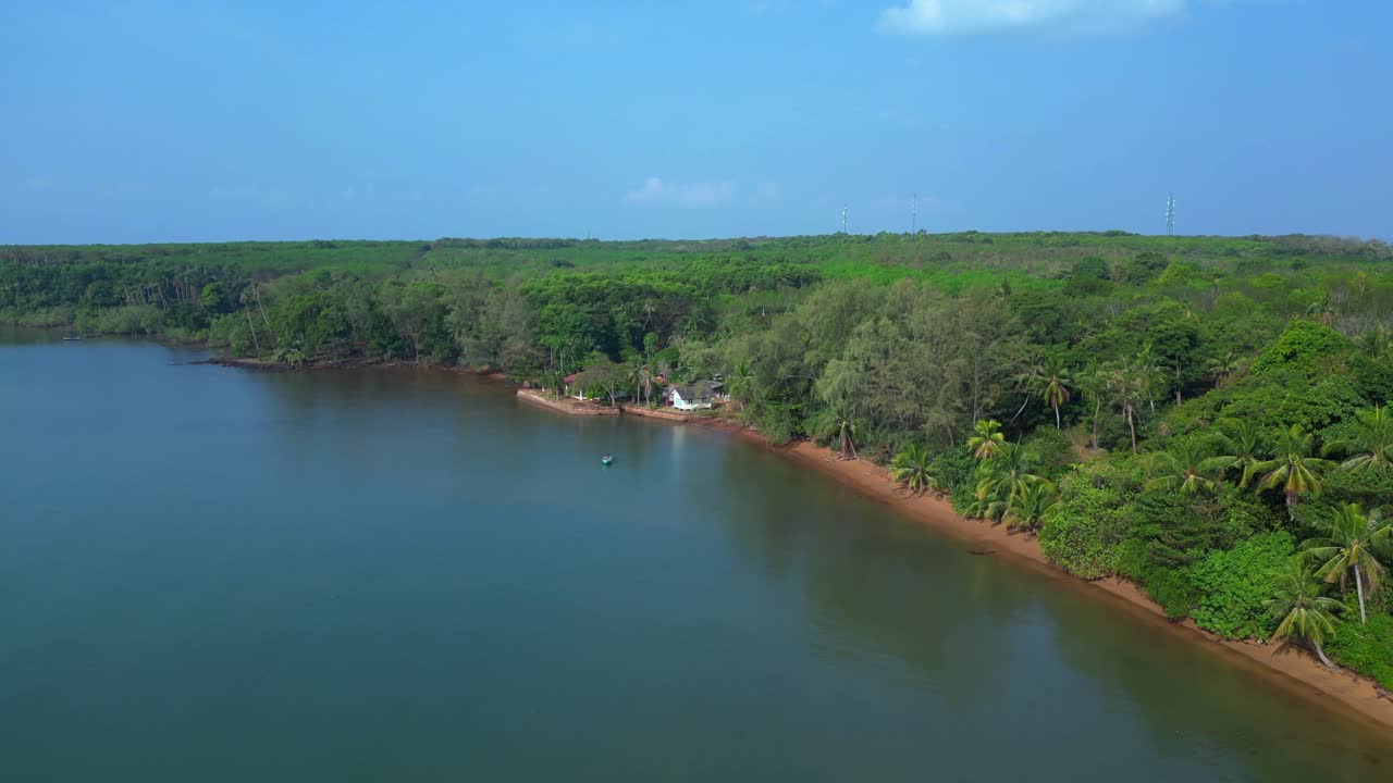 Small fishing boat floating near tropical coast of Koh Mak island, Thailand. Nice aerial view flight fly push forward drone