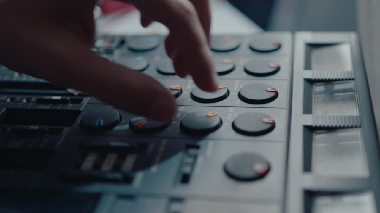 Hand of Musician Working with Vintage Multitrack Cassette Recorder