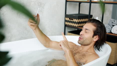 man taking a selfie in a bath