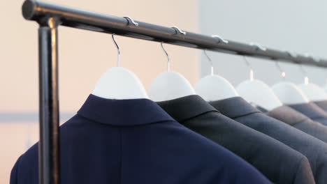 various blazers arranged in a row on cloth rack 4k