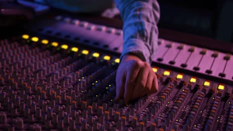 sound engineer working at a mixing desk