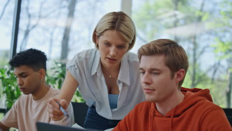 corporate supervisor helping intern coworking close up. mentor teaching employee