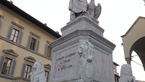 statue of dante alighieri with a laurel wreath on his head and an eagle at his side