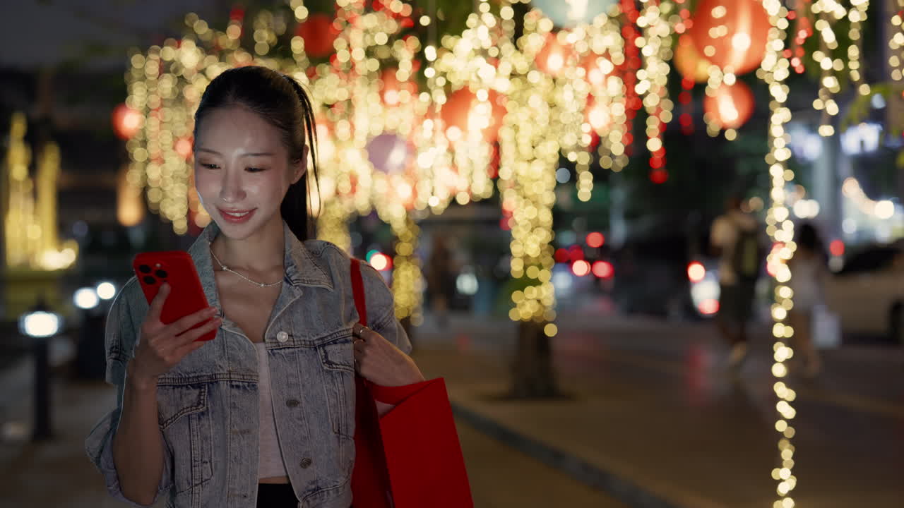 Woman using mobile phone at night in the city