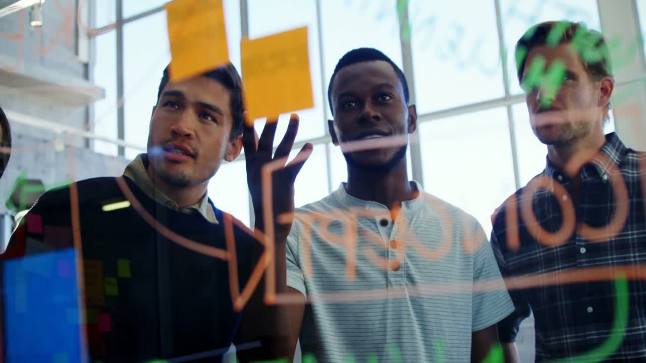 Team of executives discussing over sticky notes