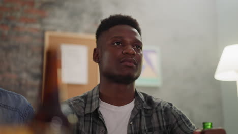 Afro-American-man-drinks-beer-and-watches-basketball