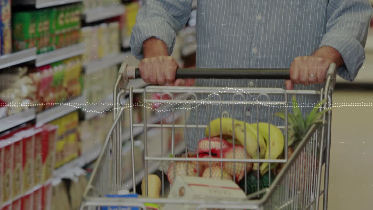 Man grasping cart, pushing groceries down aisle, smiling thumbs-up, dotted wave midline shopping