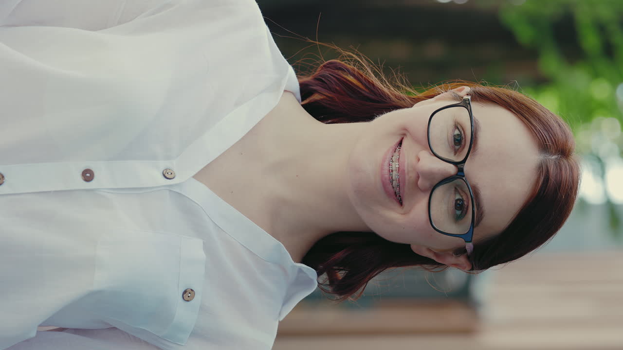 Smiling Woman with Glasses and Braces
