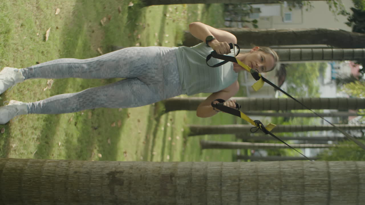 Woman Doing Suspension Straps Rows in Park