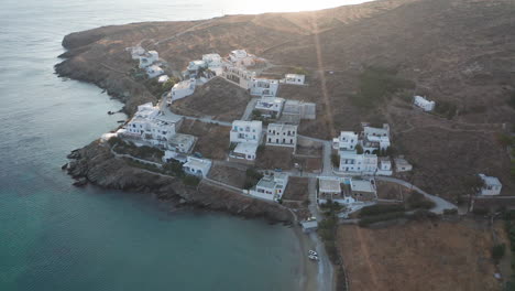 aerial drone flight circling a few white houses at the island of tinos