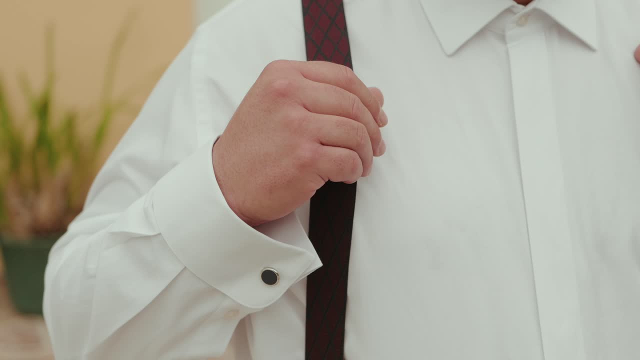 Close up of man adjusting suspenders before formal event