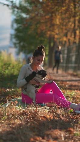 woman and pug in autumn park