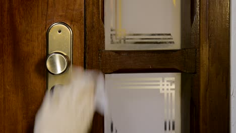 spraying alcohol gel on the door handle to disinfect