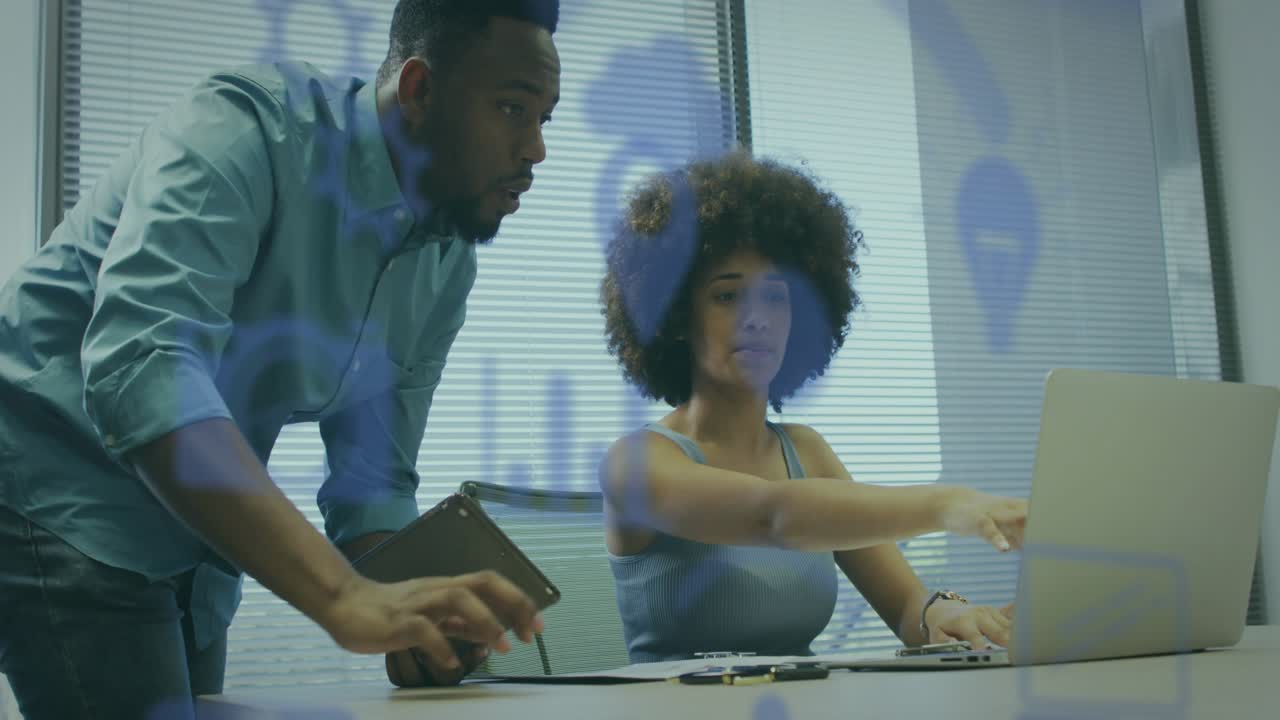 Man leaning over woman pointing at docs, guiding business laptop to confirm, blue overlays hiding