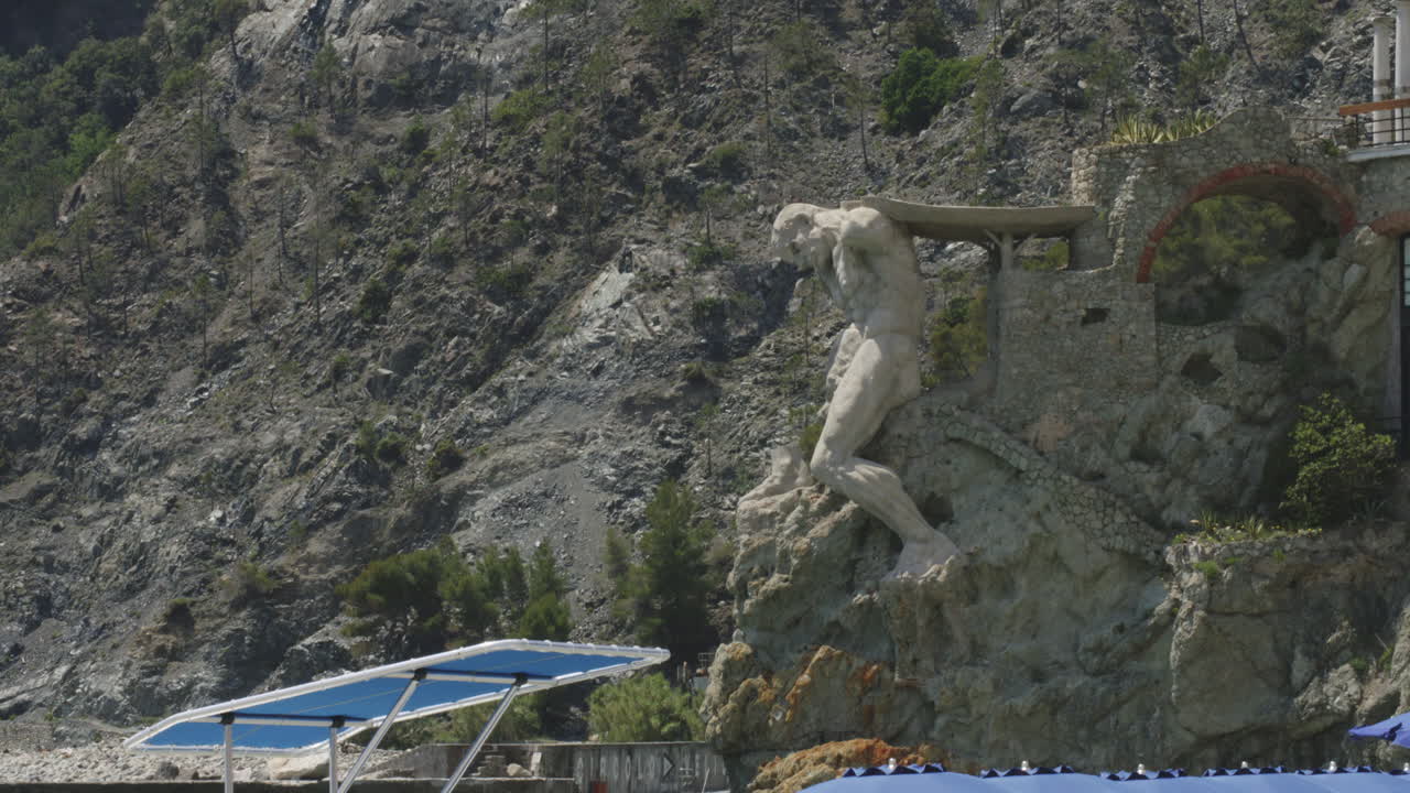 Statua del Gigante - Giant Statue Of Neptune In Italian Riviera Town Of Monterosso al Mare, Italy. tilt-down reveal