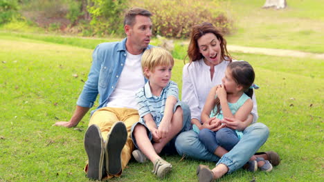 happy family sitting on grass