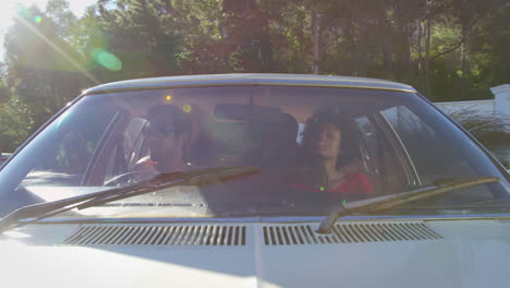 exterior view of friends in car enjoying summer road trip