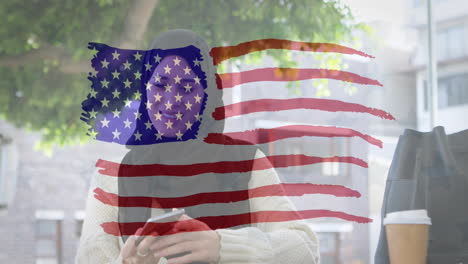 animation of american flag drawn over biracial woman in hijab taking selfies with her smartphone