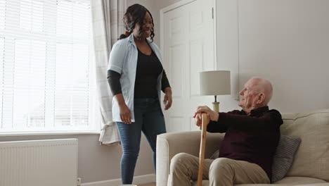 caregiver assisting senior man at home