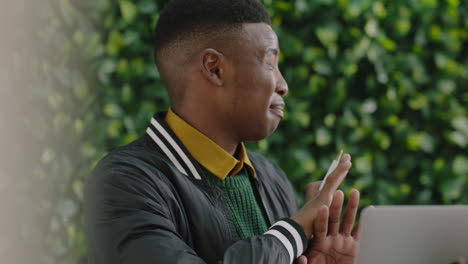 happy-young-african-american-man-student-chatting-to-colleagues-enjoying-sharing-creative-ideas-discussing-project-in-modern-office-conversation