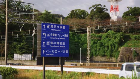 cars passing road sign in toba city, mie prefecture japan