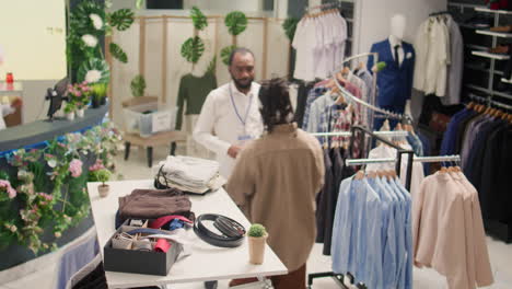 employee arranging clothes on racks