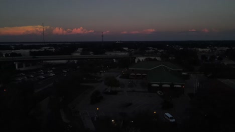 aerial-turning-in-downtown-Lakeland,-Florida-nearing-nightfall