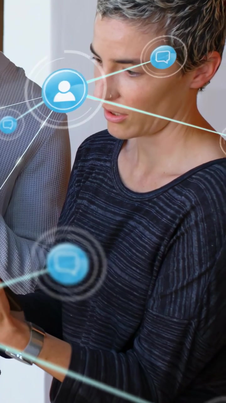 Vertical video: Woman tapping phone while man watching, blue tech net icons linking nodes for work