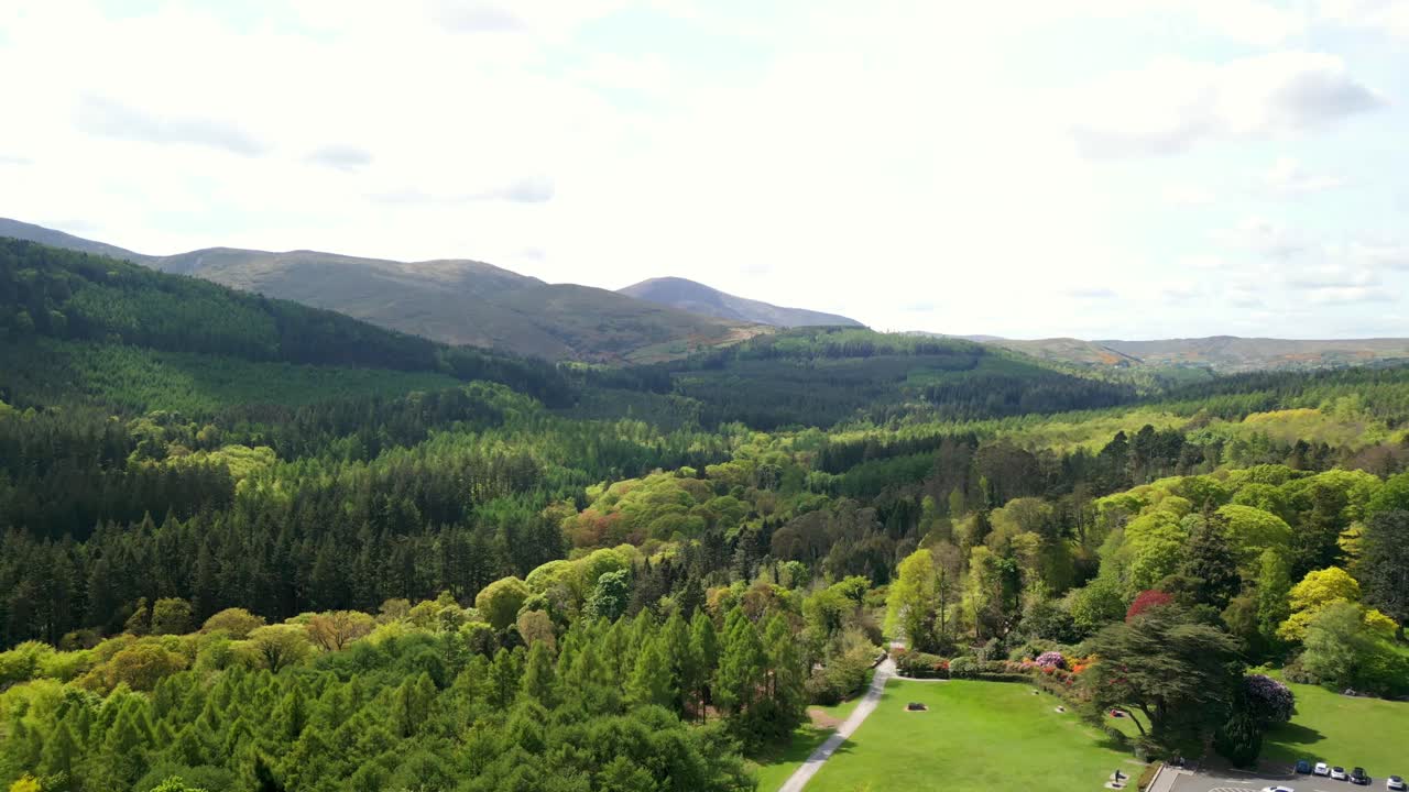 Wide advancing aerial video of the Mourne Mountains and Slieve Donard in Newcastle, County Down in Northern Ireland, UK on a bright and sunny day. Filmed in 4K, 60fps and with Rec709 Color.