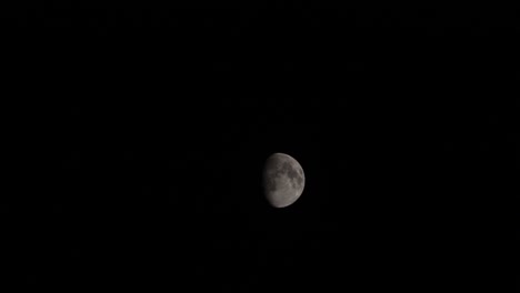 waxing gibbous phase of moon passing against black night sky