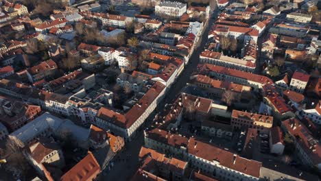 aerial: kaunas oldtown with beautiful golden hour light on medieval houses