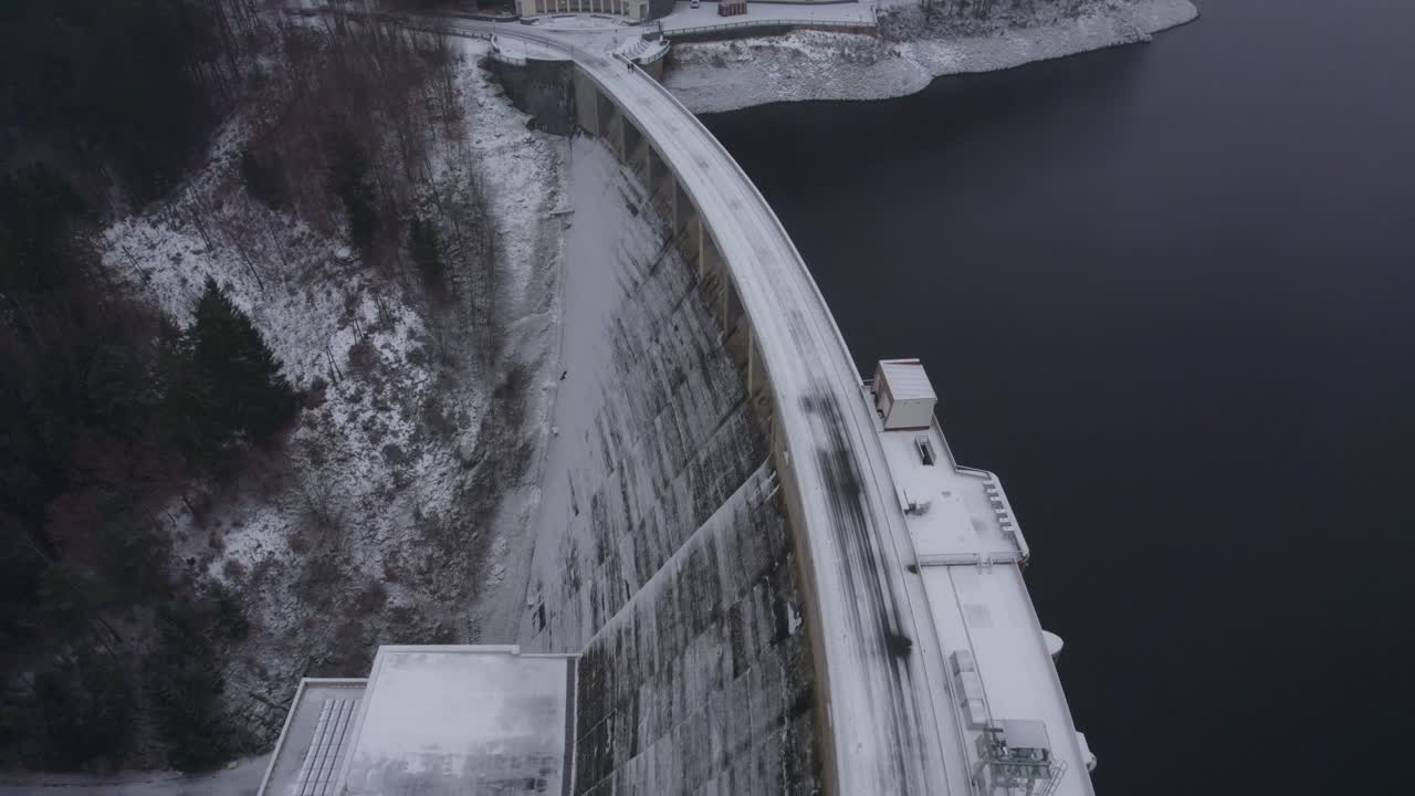 Aerial view of arch dam Vír having a hydro electric power plant in czech republic on a cold wintry evening.