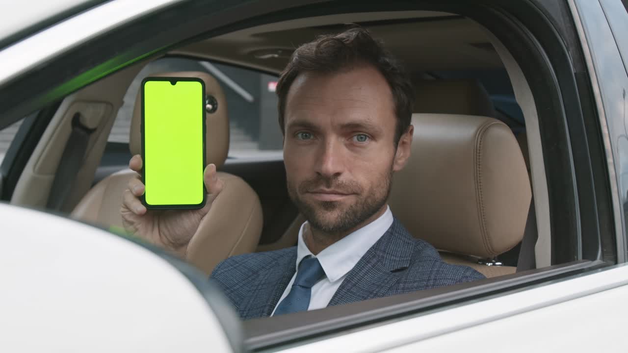 Caucasian Driver Showing Green-screened Smartphone