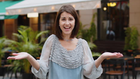 surprised frustrated young woman raising hands asking reason of failure, demonstrating disbelief