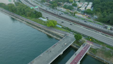 aerial top down of asphalted road bridge connecting the downton of hong kong asiatic chinese main city with traffic and pollution