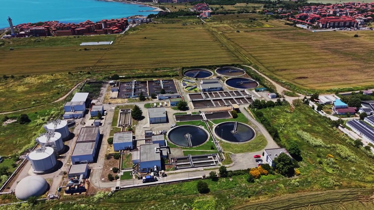Water treatment facility in an open field near city buildings