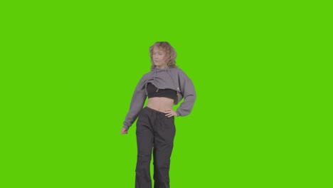 studio shot of young woman having fun dancing against green screen 27